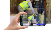 A phone app scans a construction worker lifting boxes.
